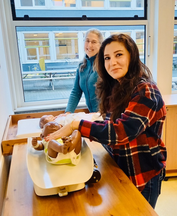 four boy playing ball on green grass