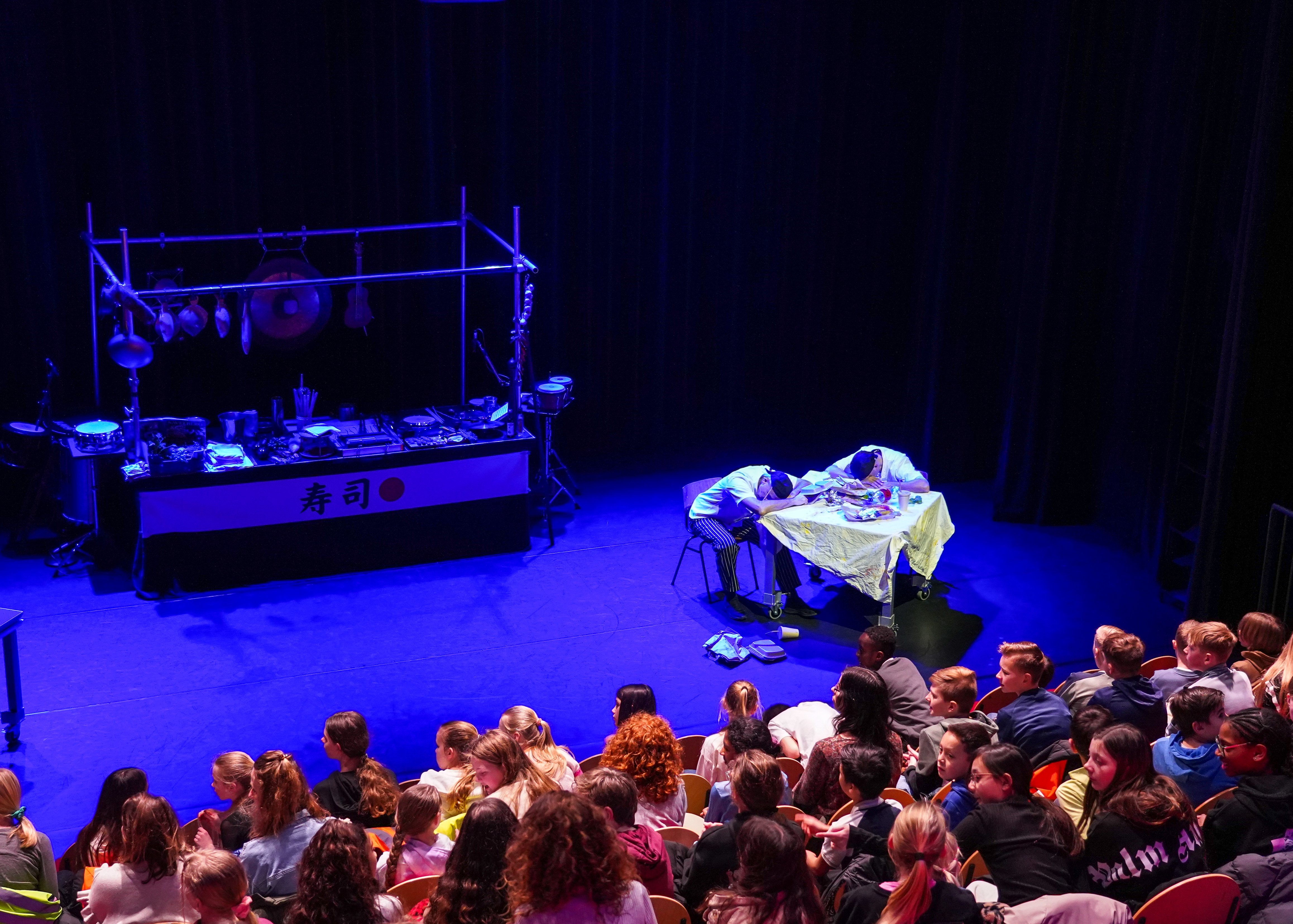 four boy playing ball on green grass